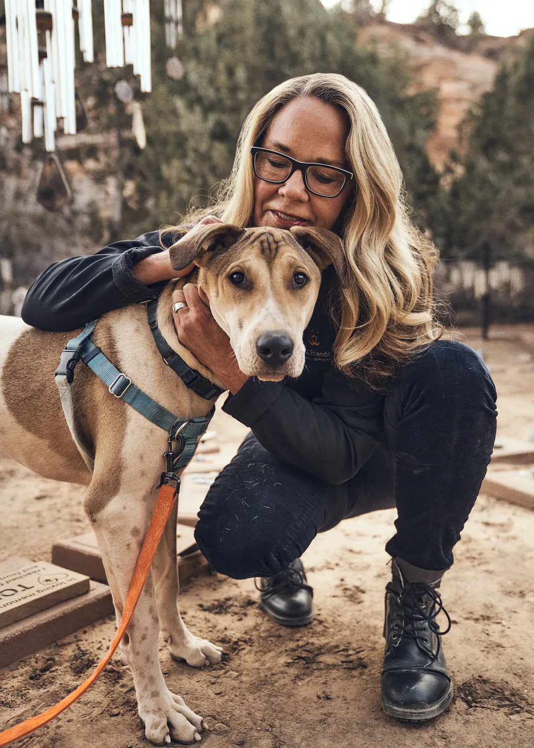 Best Friends CEO Julie Castle with Yule, a young mixed-breed dog. Yule was transferred to the Best Friends Lifesaving Center in Salt Lake City, where he found his forever home.