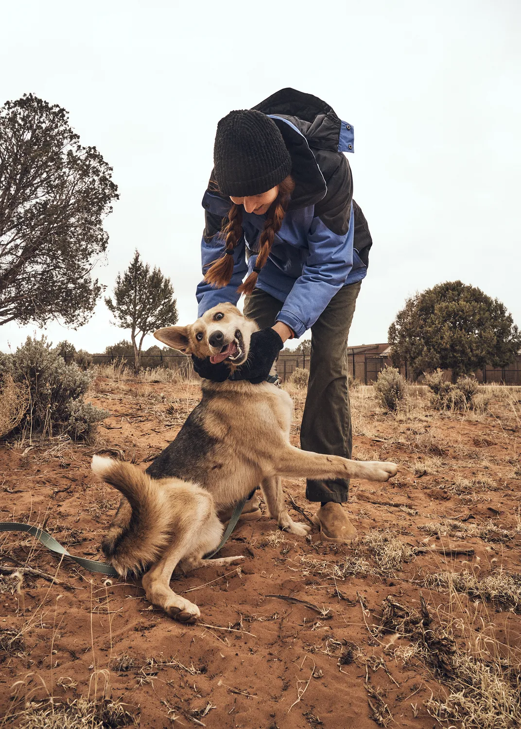 Caregiver Landon Schobert with a young dog named Carolina Reaper. The dog has since been transferred to RezDawg Rescue, an organization that collaborates with Indigenous and rural communities.