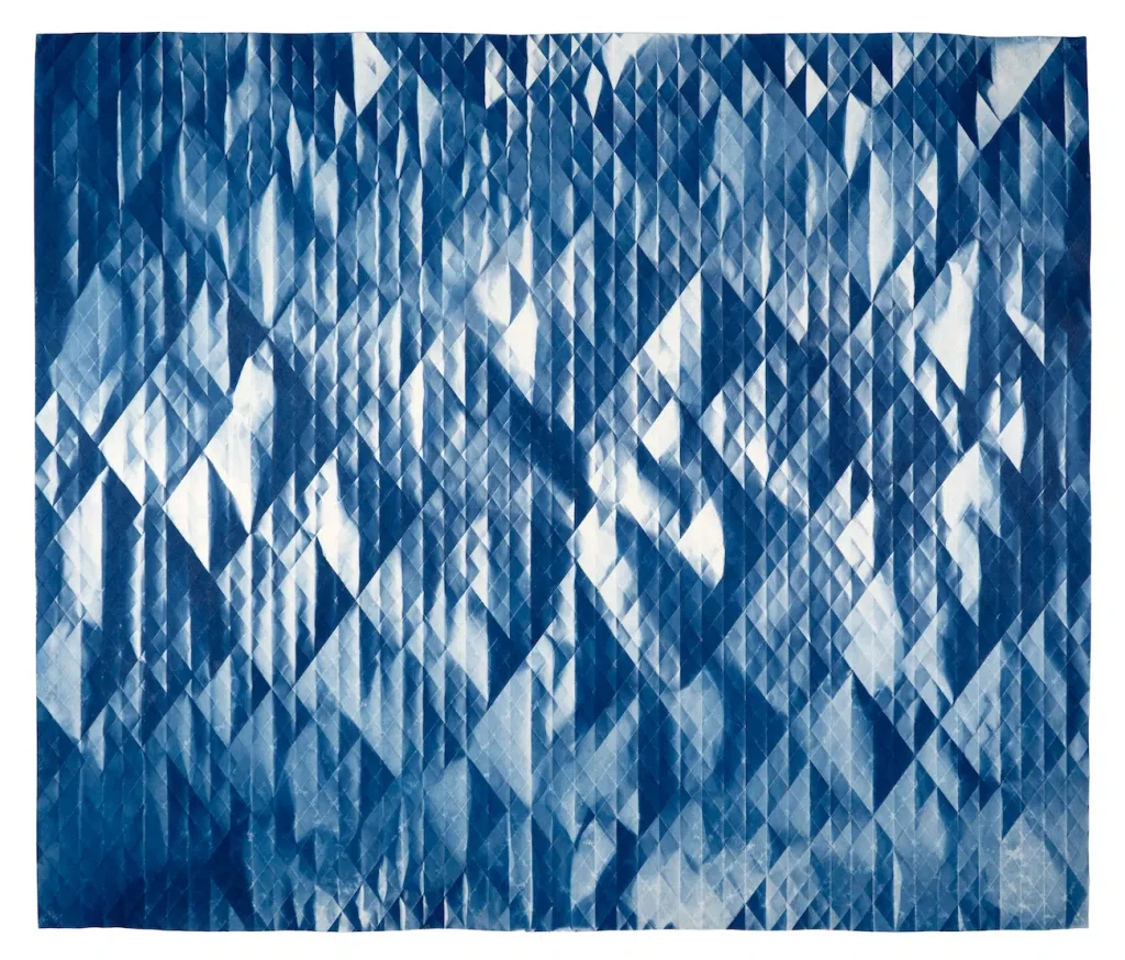Sunlight Uncovers Crystal Designs in Cyanotypes of Crumpled Paper Tessellations