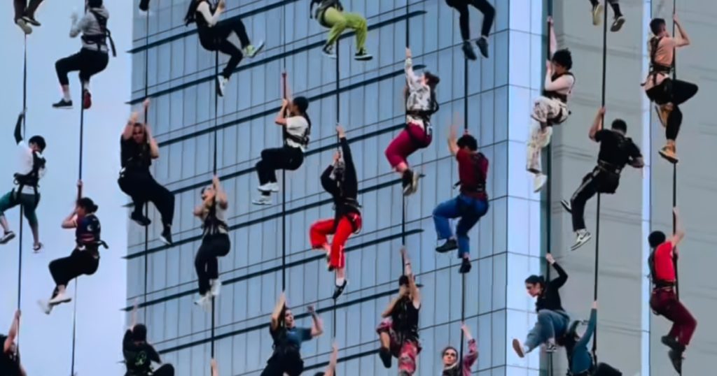 Dancers Execute Aerial Stunts, Crafting the Appearance of Ascending into the Sky in a Stunning Performance