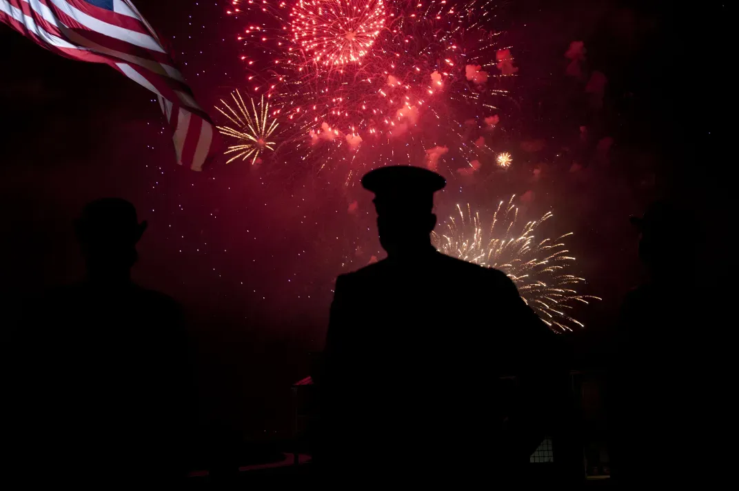 14 - A soldier from the U.S. Army at Fort McHenry in Baltimore observes fireworks lighting up the sky to commemorate the 200th anniversary of “The Star-Spangled Banner.”