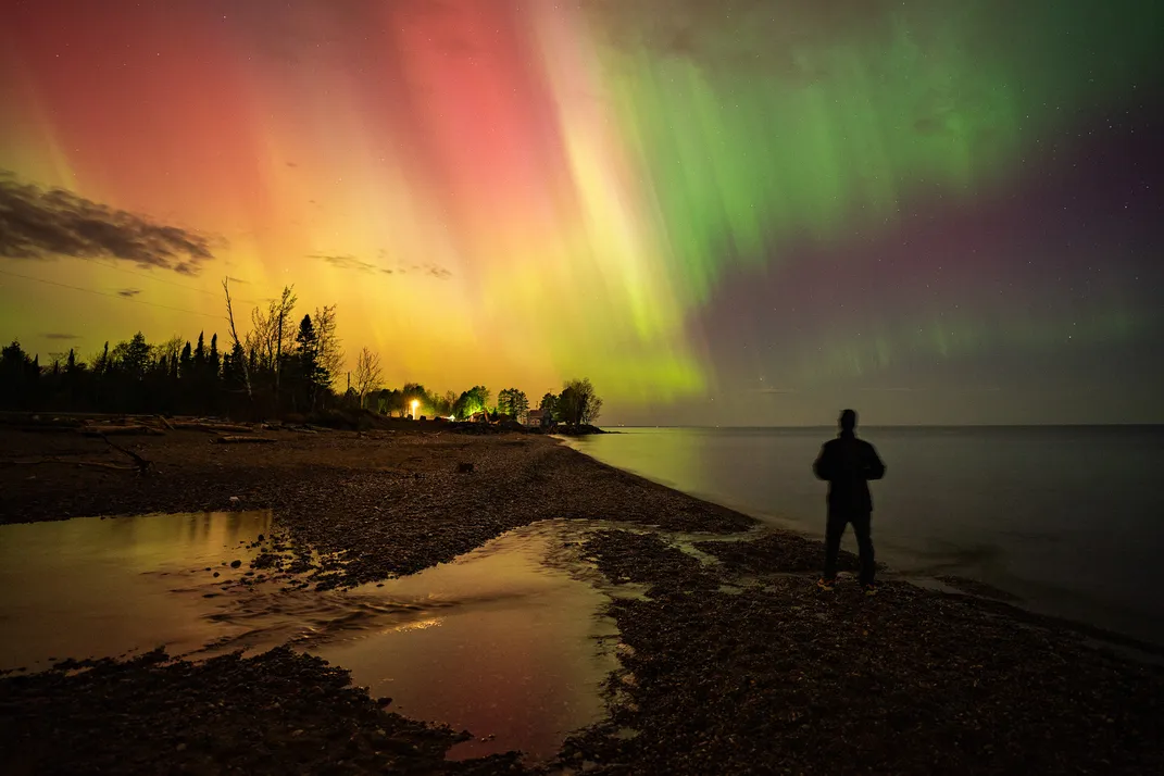 northern lights dance in the sky above Lake Michigan