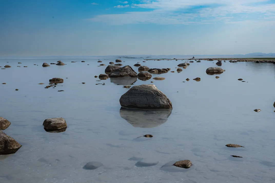 boulders break the still surface of Lake Michigan